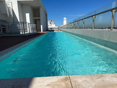 a swimming pool on the roof of a building at deptomardel_playa in Mar del Plata