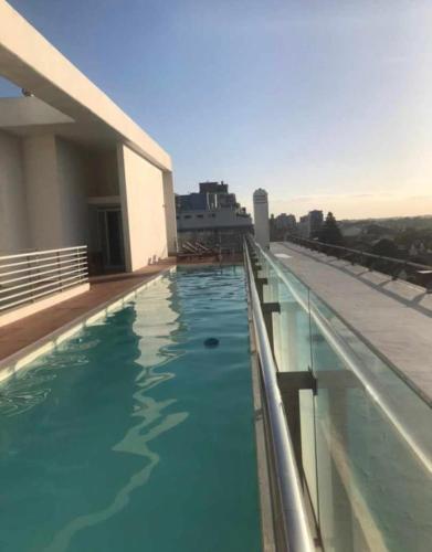 a swimming pool on the roof of a building at deptomardel_playa in Mar del Plata