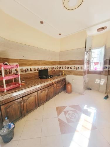 a kitchen with wooden cabinets and a counter top at Appartement de luxe Nour in Fez