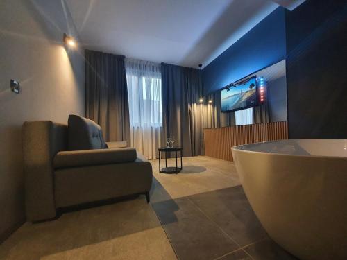 uma sala de estar com uma banheira e uma televisão em Avenue21 em Zagreb