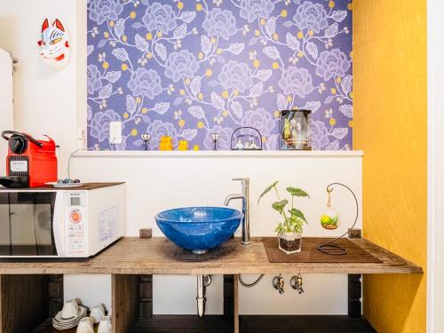 a kitchen counter with a blue bowl on top of it at KYARA Hotel 浅草 in Tokyo