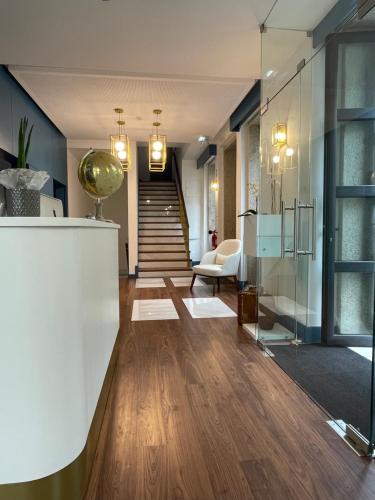 a living room with a staircase and a lobby at BLUE ANCORA HOTEL in Vila Praia de Âncora