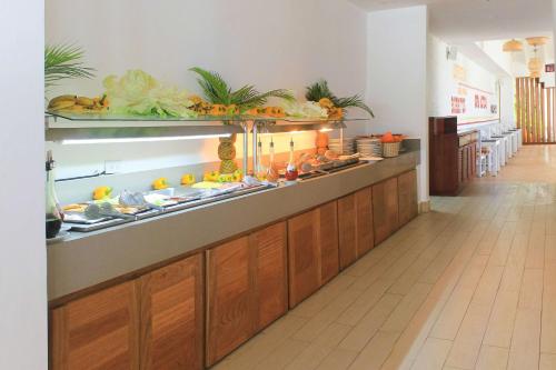 a buffet line in a restaurant with fruits and vegetables at Viva Tangerine by Wyndham, A Trademark All Inclusive in Cabarete