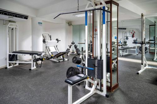 a gym with several machines and a mirror at Viva Tangerine by Wyndham, A Trademark All Inclusive in Cabarete