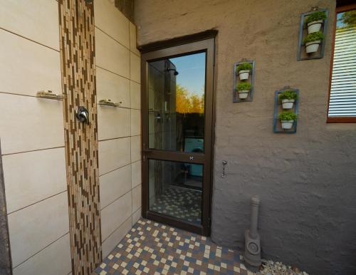 a bathroom with a shower with a glass door at Bushveld Jewel - Close to Kruger in Hoedspruit
