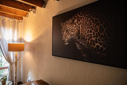 a painting of a jaguar on a wall at Bushveld Jewel - Close to Kruger in Hoedspruit