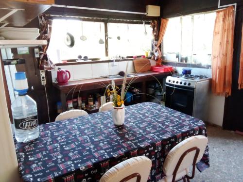 a kitchen with a table with a blue and white table cloth at Refugio de paz in Jaureguiberry