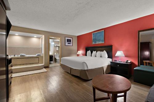 a hotel room with a large bed and a bath tub at Quality Inn Wayne - Fairfield Area in Wayne