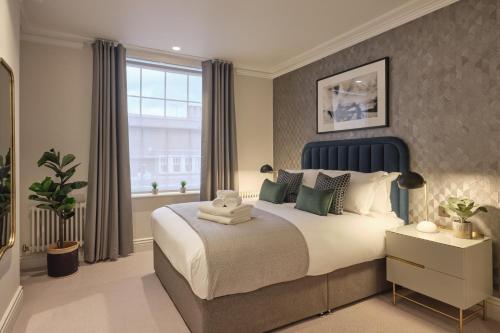a bedroom with a large bed and a window at Darley House by Viridian Apartments in London