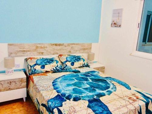 a bedroom with a bed with a turtle comforter at La Terraza Fuerteventura in Puerto del Rosario