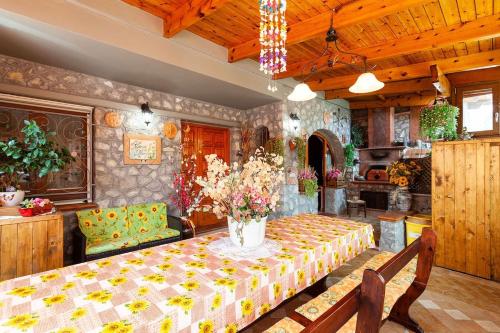 a dining room with a table with flowers on it at Casa Nicolò in Massa Lubrense