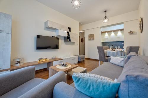 a living room with a couch and a dining room at Apartmani Montis Zlatibor in Zlatibor