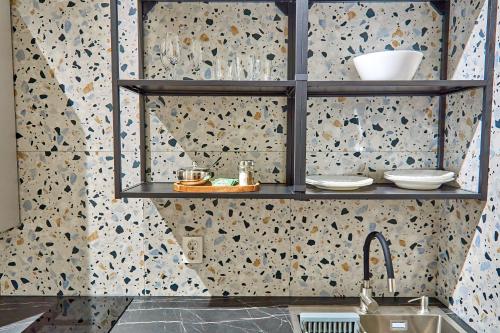 a kitchen with a sink and a shelf with dishes at Best Apartments on Kyryla & Mefodia in Mukacheve