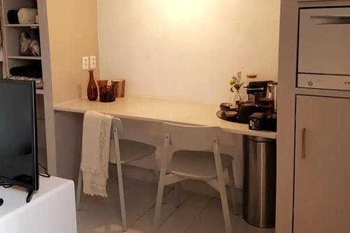 a kitchen with a counter with a table and chairs at The Superstay Boutique guestroom in Amsterdam