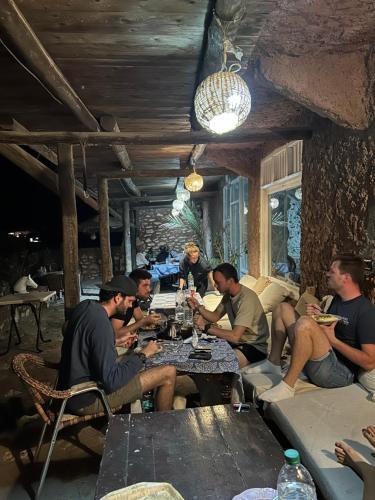 a group of men sitting around a table eating at SurfcampLagrotte in Essaouira