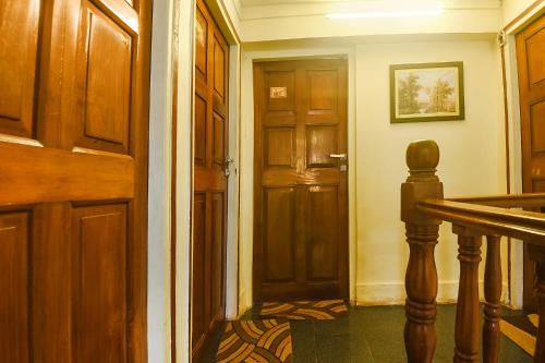 an entrance to a hallway with a wooden door at FabHotel Royal Baga Residency in Old Goa