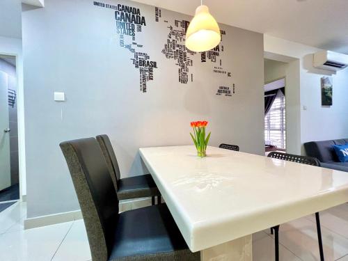 a dining room with a white table and chairs at D'Putra Suites 2BR Kulai by Luxecocoo CK in Kampong Saleng