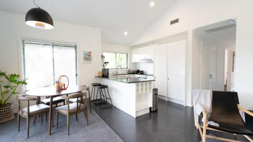 a kitchen and dining room with a table and chairs at Mike's Kangaroo Valley in Kangaroo Valley