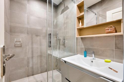 a bathroom with a shower and a sink and a shower at Urban Flat 73 - Luxury Parisian Flat near Les Halles Rivoli in Paris