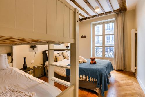 a bedroom with two bunk beds and a teddy bear on a bed at Urban Flat 73 - Luxury Parisian Flat near Les Halles Rivoli in Paris