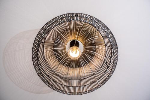 a metal chandelier hanging from a ceiling at Villa Nónna, 1800s house renovated in 2023 in Fiskardho