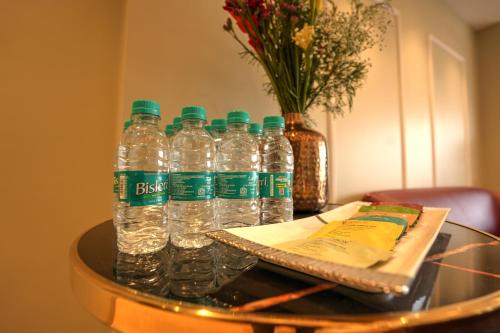 un grupo de botellas de agua sobre una mesa en Hotel RJ - Managed by AHG, en Greater Noida