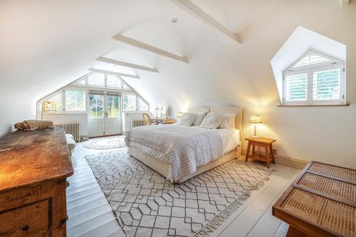 a white bedroom with a bed and a window at Fern House in Dorchester