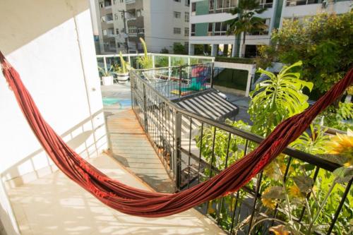 a hammock on the balcony of a building at The Place Hostel in Recife