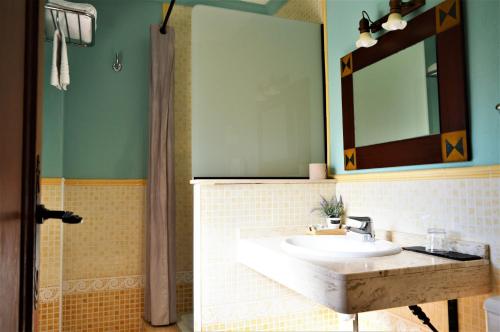 a bathroom with a sink and a mirror at Hotel Rural Alfajía de Antonio in Capileira