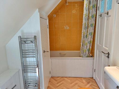 a small bathroom with a bath tub and a ladder at Finest Retreats - Little Dunley - Lake View in Bovey Tracey