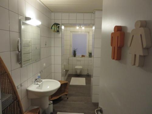 a small bathroom with a sink and a toilet at Ferienwohnung Familie Buchner in Großheubach