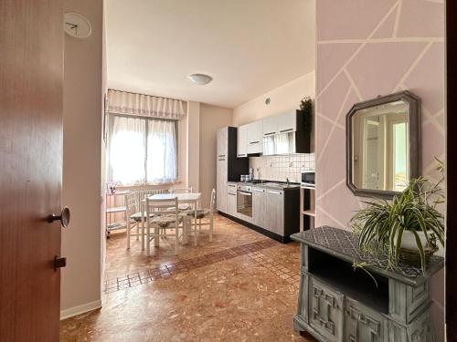 a kitchen with a table and a dining room at Casa TOÈ in Conegliano