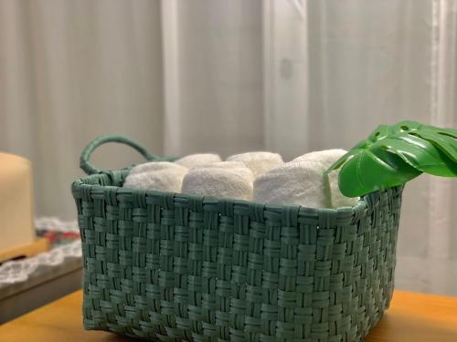 a basket of towels sitting on a table at Damso stay in Seoul