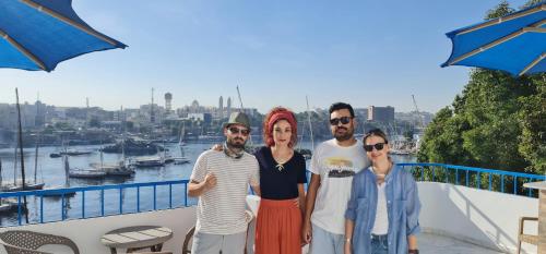 a group of people posing for a picture on a balcony at La Terrace in Aswan