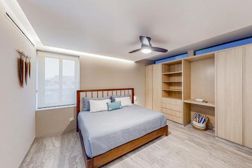 a bedroom with a bed and a large window at Cardinal Living San Jose del Cabo D-301 in San José del Cabo