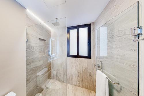 a bathroom with a shower and a window at Cardinal Living San Jose del Cabo D-301 in San José del Cabo