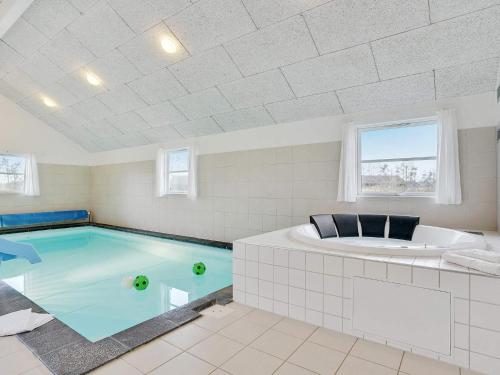 - Piscina con bañera y bañera de hidromasaje en 24 person holiday home in Idestrup, en Bøtø By