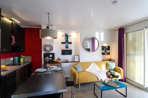a kitchen and living room with a yellow couch at Le Bobillot By ApiRent #Central #Terrasse #Wifi #Clim in Cannes