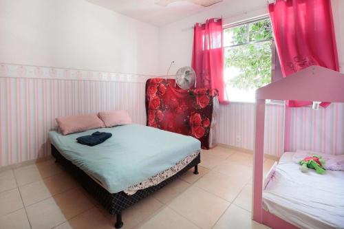 a room with two beds and a chair and a window at Casa Branca 355 Familiar in Rio de Janeiro