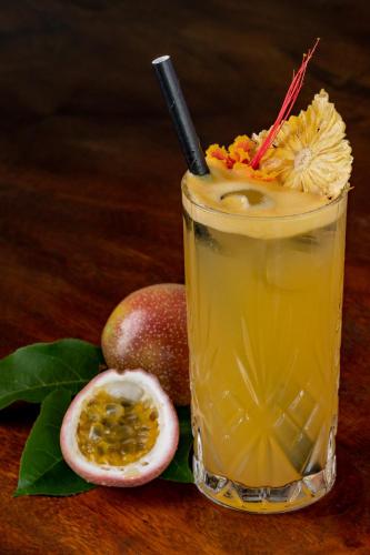 a drink with a slice of fruit on a table at Nau Villa Ubud in Tegalalang