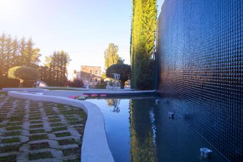 a pool of water next to a brick wall at ELITE LUXURY BOUTIQUE in Fier