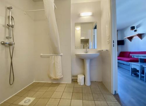 a bathroom with a sink and a shower at Vacancéole - Le Borsat IV in Tignes