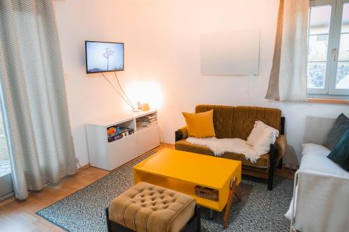 a living room with a couch and a yellow table at Cottage in Domasa 2 