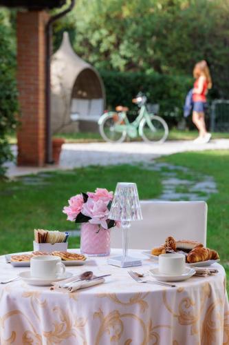 a white table with food and flowers on it at Hotel Acapulco in Forte dei Marmi