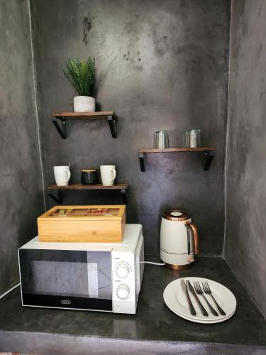 a kitchen with a microwave and a plate on a counter at A Step Ahead in Klerksdorp