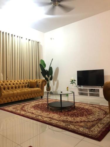 a living room with a couch and a coffee table at D' HOME MERIDIAN in Kluang