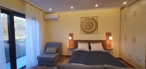 a bedroom with a bed and a chair at Studio apartmani Anika in Vrdnik