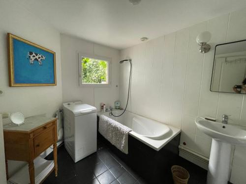 uma casa de banho com um lavatório, uma banheira e um WC. em Appartement cœur de Ville Vichy em Vichy