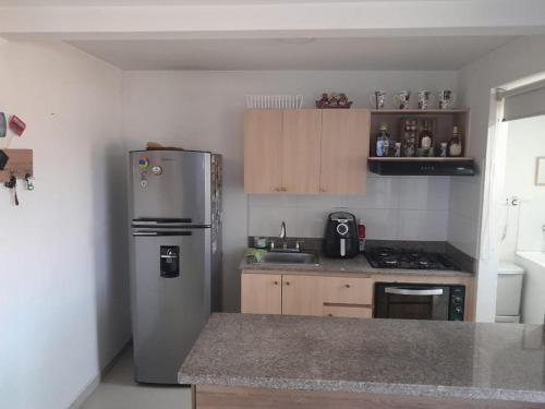 a kitchen with a stainless steel refrigerator and a sink at Apartamento inigualable en la ciudad de Medellín excelente vista piso 25 in Medellín