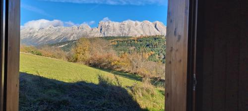 a view of a mountain from a window at Gîte du Faraud in Le Dévoluy